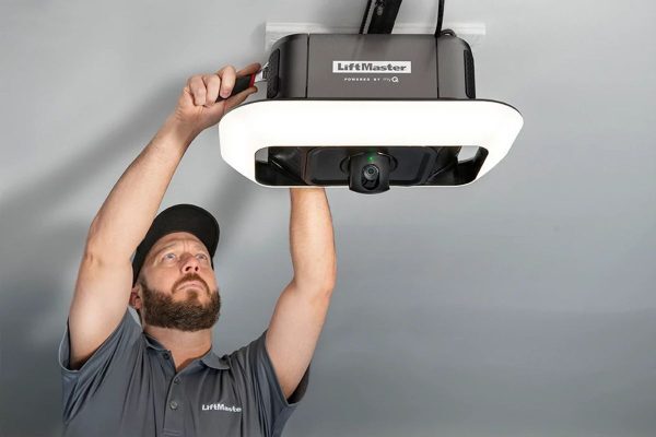 echnician installing a LiftMaster smart garage door opener with built-in camera